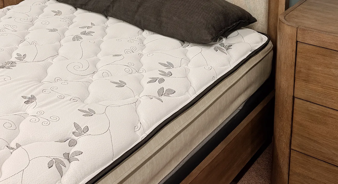 Quilted pillow top mattress on a wood bed frame in the Northwest Decor & Furniture showroom, Sheldon, IA