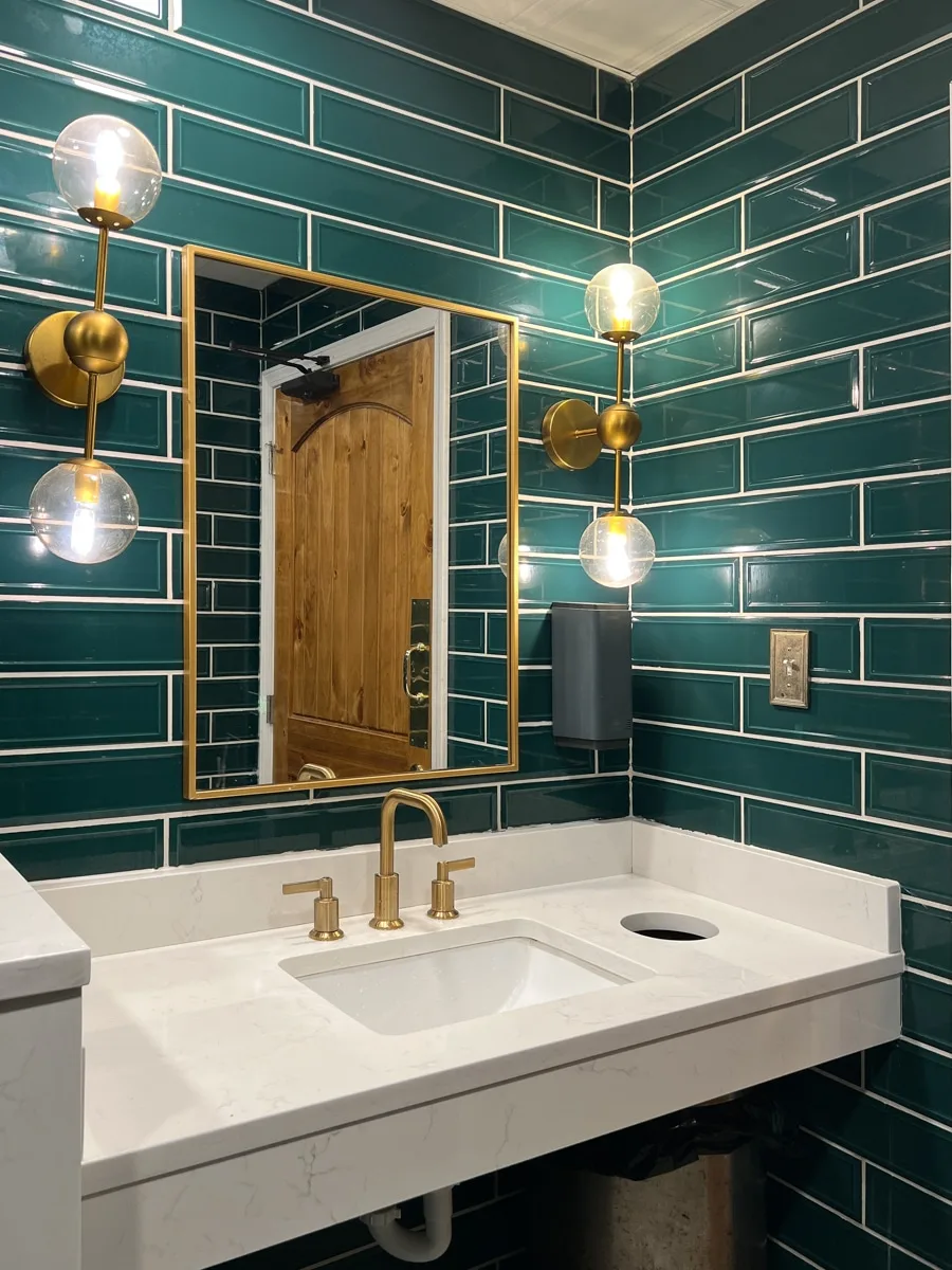 Green tile wall in a commercial restroom